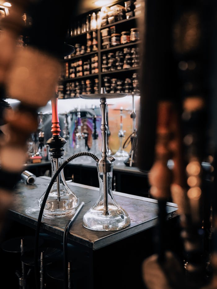 Cozy hookah lounge featuring various hookah pipes on display.
