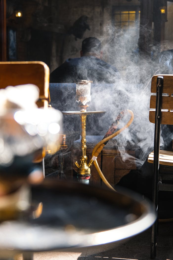 Stylish hookah lounge with smoke and cozy seating. Perfect for relaxation.